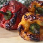Peperoni arrostiti in friggitrice ad aria uno rosso e due gialli